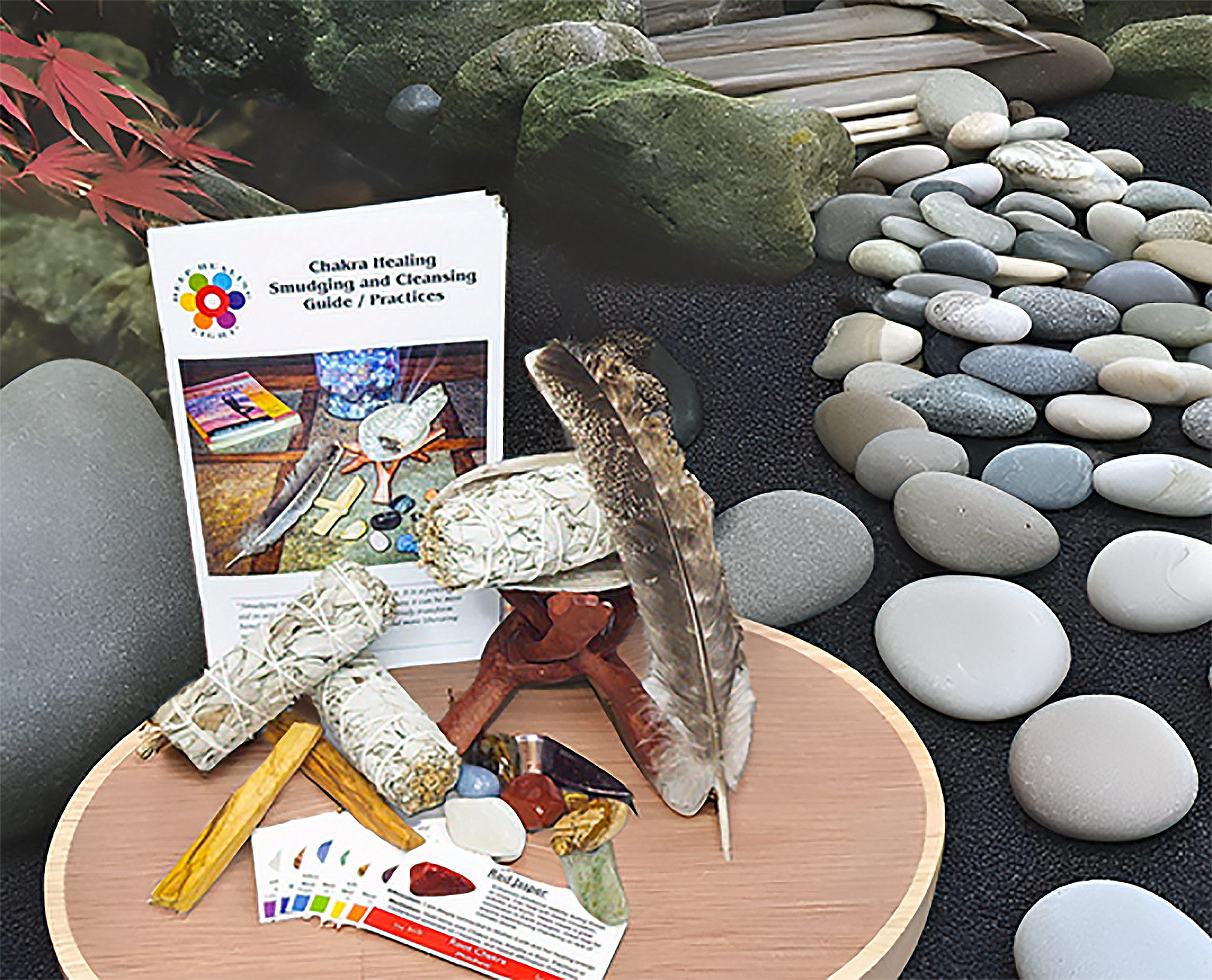 Chakra smudging and cleansing kit with sage, Palo Santo, shell, feather, chakra stones, and chakra cards